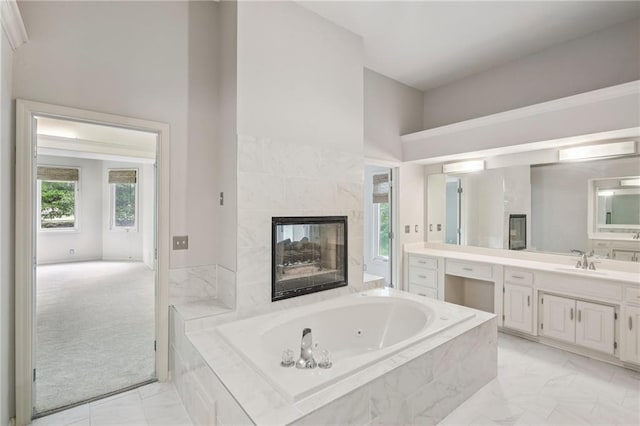 12909 Maple St, Overland Park, KS 66209 - bathroom with vanity, marble finish flooring, a whirlpool tub, and a fireplace