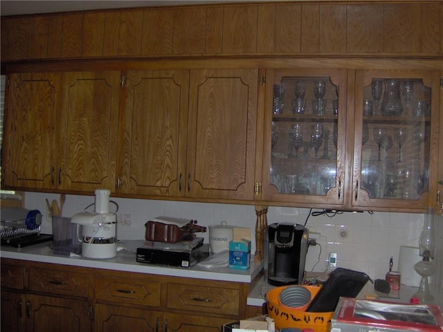 3016 S Northern Blvd, Independence, MO 64052 - kitchen featuring light countertops, decorative backsplash, and brown cabinets