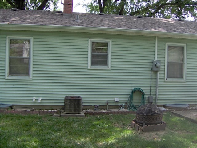 3016 S Northern Blvd, Independence, MO 64052 - back of property with a fire pit, a shingled roof, a chimney, and a yard