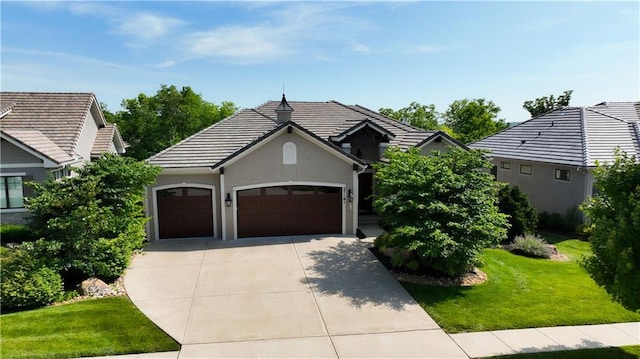 27181 W 100th Ter, Olathe, KS 66061 - view of front of property featuring an attached garage, driveway, a front lawn, stucco siding, and a tiled roof