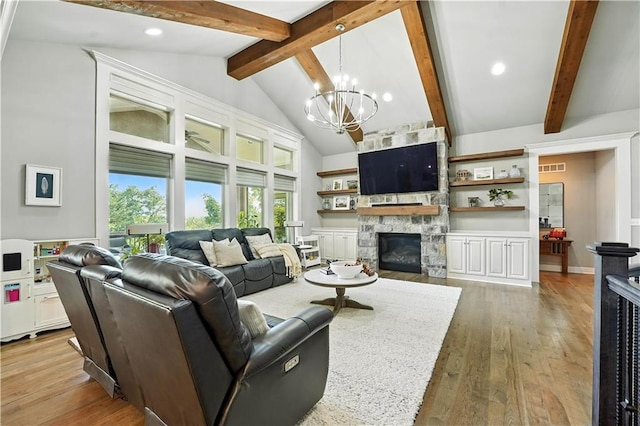27181 W 100th Ter, Olathe, KS 66061 - living room with a chandelier, beam ceiling, a stone fireplace, light wood-style flooring, and recessed lighting