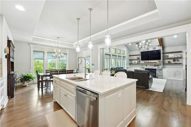 27181 W 100th Ter, Olathe, KS 66061 - kitchen with stainless steel dishwasher, a chandelier, a tray ceiling, a fireplace, and recessed lighting