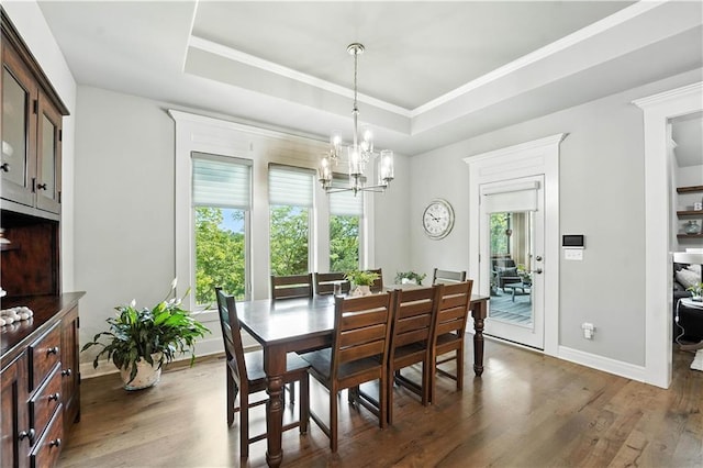 27181 W 100th Ter, Olathe, KS 66061 - dining space featuring a chandelier, a raised ceiling, wood finished floors, and ornamental molding