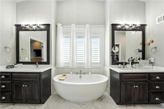 27181 W 100th Ter, Olathe, KS 66061 - full bath featuring marble finish floors, a freestanding tub, and two vanities