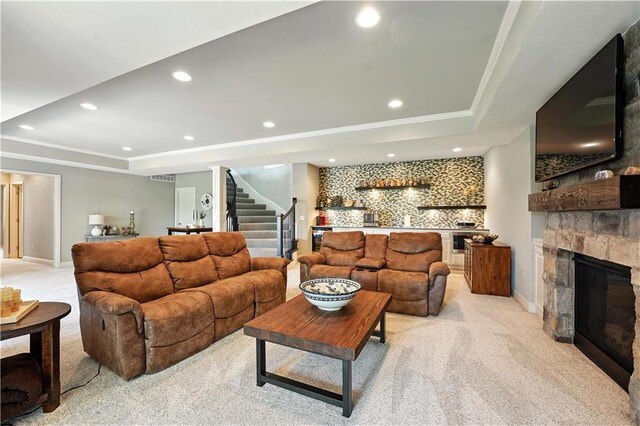 27181 W 100th Ter, Olathe, KS 66061 - living area with light colored carpet, a raised ceiling, a dry bar, stairway, and recessed lighting