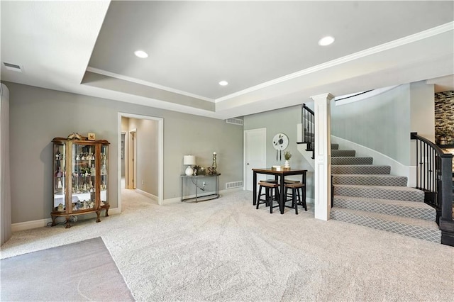 27181 W 100th Ter, Olathe, KS 66061 - carpeted living area featuring stairs, a tray ceiling, recessed lighting, and crown molding