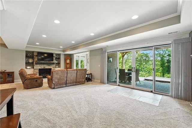 27181 W 100th Ter, Olathe, KS 66061 - carpeted living room with a raised ceiling, ornamental molding, a fireplace, and recessed lighting