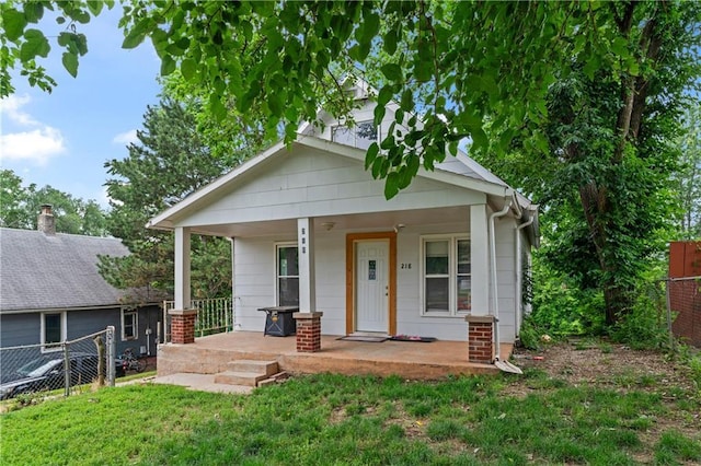 218 N 25th St, Kansas City, KS 66102 - bungalow-style house featuring a porch