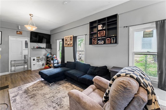 218 N 25th St, Kansas City, KS 66102 - living room with wood finished floors and healthy amount of natural light