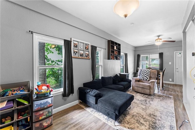 218 N 25th St, Kansas City, KS 66102 - living room featuring wood finished floors and a ceiling fan