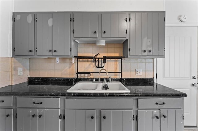 218 N 25th St, Kansas City, KS 66102 - kitchen featuring gray cabinets, decorative backsplash, and dark stone countertops