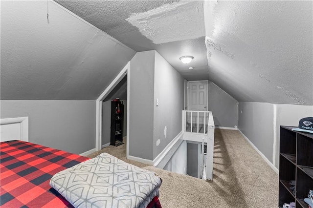 218 N 25th St, Kansas City, KS 66102 - carpeted bedroom featuring a textured ceiling and vaulted ceiling
