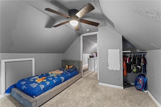 218 N 25th St, Kansas City, KS 66102 - carpeted bedroom with lofted ceiling, a textured ceiling, a closet, and a ceiling fan