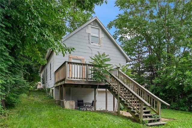 218 N 25th St, Kansas City, KS 66102 - rear view of property featuring stairway, a wooden deck, and a lawn