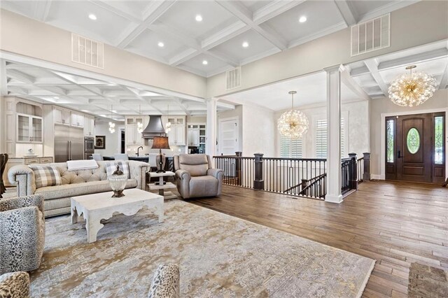 18405 371st Hwy, Platte City, MO 64079 - living area featuring coffered ceiling, a chandelier, decorative columns, hardwood / wood-style floors, and beamed ceiling