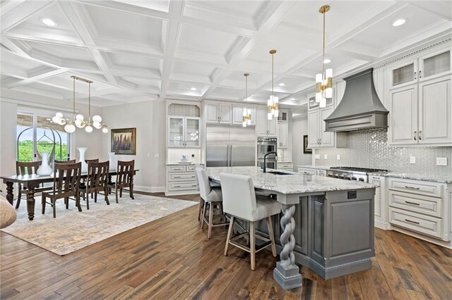 18405 371st Hwy, Platte City, MO 64079 - kitchen featuring custom exhaust hood, stainless steel appliances, dark wood finished floors, a kitchen island with sink, and decorative backsplash