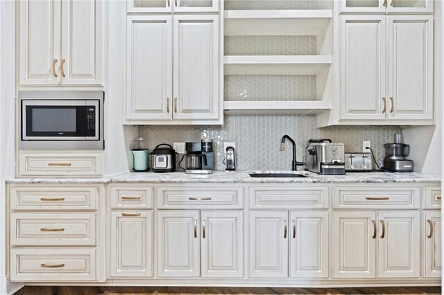 18405 371st Hwy, Platte City, MO 64079 - kitchen with stainless steel microwave, glass insert cabinets, and tasteful backsplash