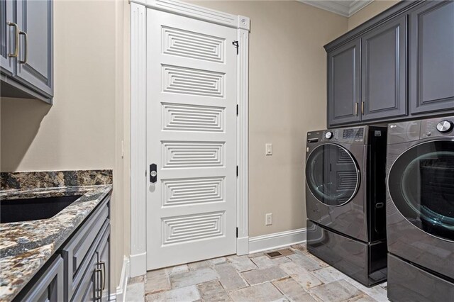 18405 371st Hwy, Platte City, MO 64079 - laundry area with cabinet space, washer and clothes dryer, stone tile floors, and crown molding