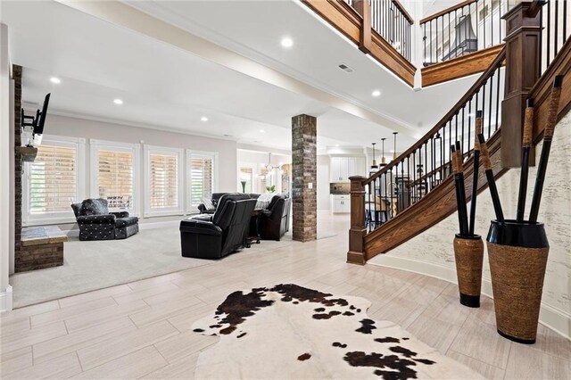 18405 371st Hwy, Platte City, MO 64079 - living area with decorative columns, stairway, crown molding, recessed lighting, and wood tiled floors