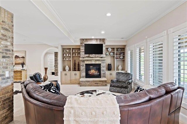 18405 371st Hwy, Platte City, MO 64079 - living room featuring ornamental molding, a fireplace, recessed lighting, and arched walkways