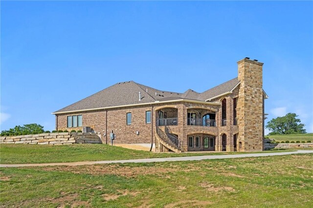18405 371st Hwy, Platte City, MO 64079 - back of house with a lawn, a chimney, brick siding, and stairs