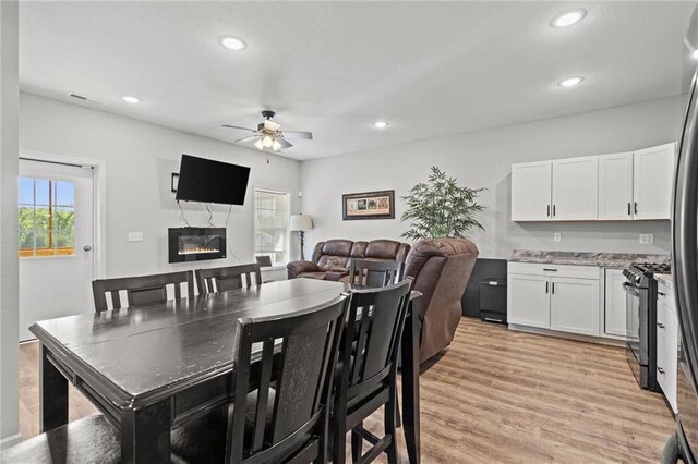 18405 371st Hwy, Platte City, MO 64079 - dining room with a ceiling fan, a glass covered fireplace, recessed lighting, and light wood-style floors