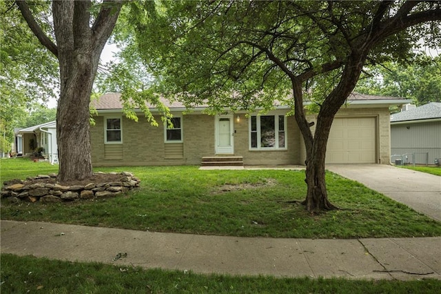 2105 Calumet Dr, Independence, MO 64057 - single story home featuring driveway, an attached garage, brick siding, and a front yard