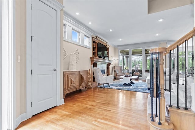 4204 SW Duck Pond Dr, Lees Summit, MO 64082 - workout area featuring light wood-style floors, recessed lighting, a fireplace, and ornamental molding
