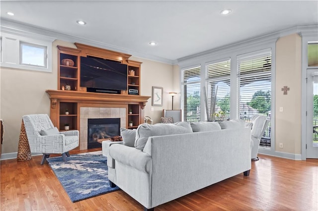 4204 SW Duck Pond Dr, Lees Summit, MO 64082 - living room featuring ornamental molding, plenty of natural light, a tile fireplace, recessed lighting, and wood finished floors