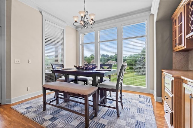 4204 SW Duck Pond Dr, Lees Summit, MO 64082 - dining area with ornamental molding, a chandelier, and light wood finished floors