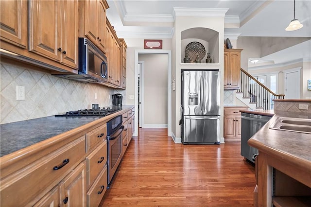 4204 SW Duck Pond Dr, Lees Summit, MO 64082 - kitchen featuring stainless steel appliances, ornamental molding, wood finished floors, tasteful backsplash, and pendant lighting