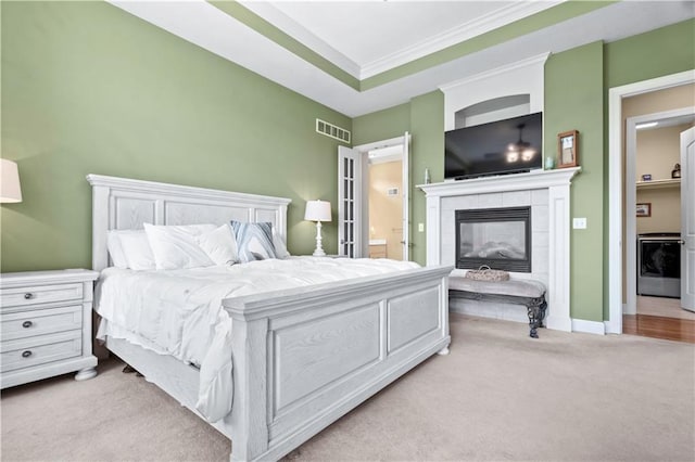 4204 SW Duck Pond Dr, Lees Summit, MO 64082 - bedroom featuring light colored carpet, a tiled fireplace, washer / dryer, ornamental molding, and ensuite bathroom