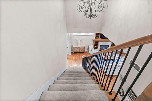 4204 SW Duck Pond Dr, Lees Summit, MO 64082 - stairway with a chandelier, a towering ceiling, and a glass covered fireplace