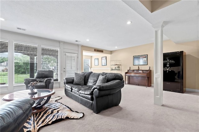 4204 SW Duck Pond Dr, Lees Summit, MO 64082 - carpeted living area with decorative columns, recessed lighting, and a textured ceiling