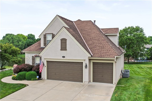 4204 SW Duck Pond Dr, Lees Summit, MO 64082 - view of front of home with stucco siding, concrete driveway, a shingled roof, and an attached garage