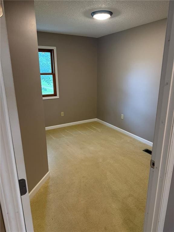 915 Des Moines St, Burlington, KS 66839 - spare room featuring a textured ceiling and light carpet