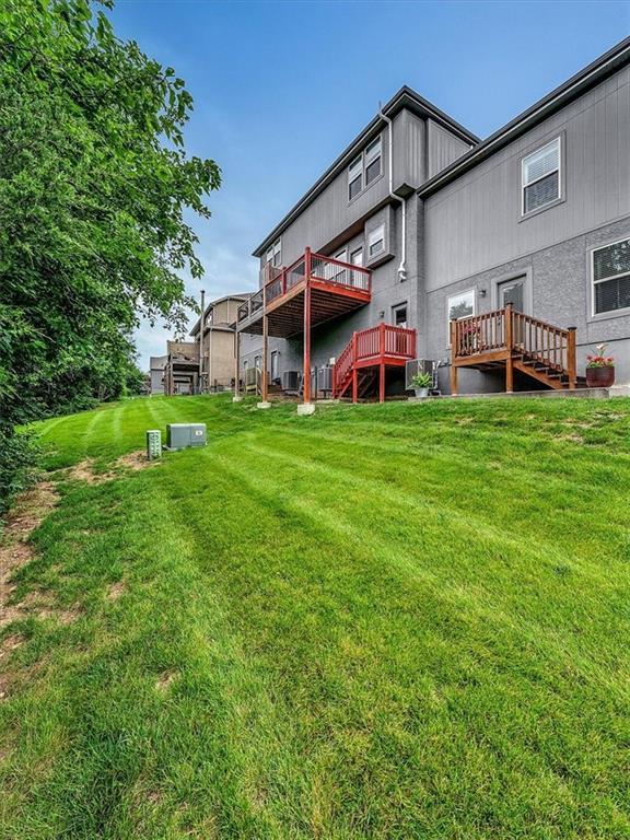 21818 W 123rd Ter, Olathe, KS 66061 - rear view of property with a yard and a wooden deck