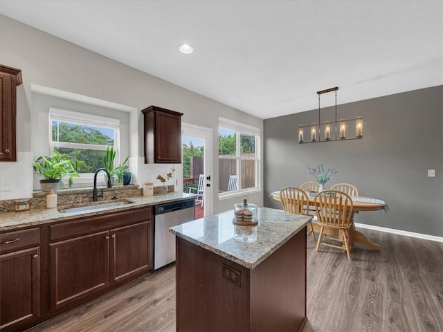 21818 W 123rd Ter, Olathe, KS 66061 - kitchen featuring stainless steel dishwasher, dark wood-style flooring, light stone counters, and healthy amount of natural light