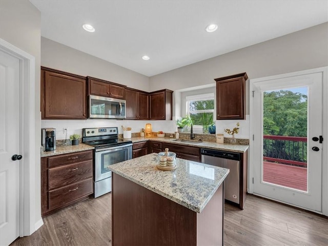21818 W 123rd Ter, Olathe, KS 66061 - kitchen with appliances with stainless steel finishes, dark brown cabinetry, light wood-style floors, and recessed lighting