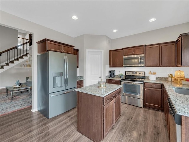 21818 W 123rd Ter, Olathe, KS 66061 - kitchen with appliances with stainless steel finishes, wood finished floors, light stone counters, and recessed lighting