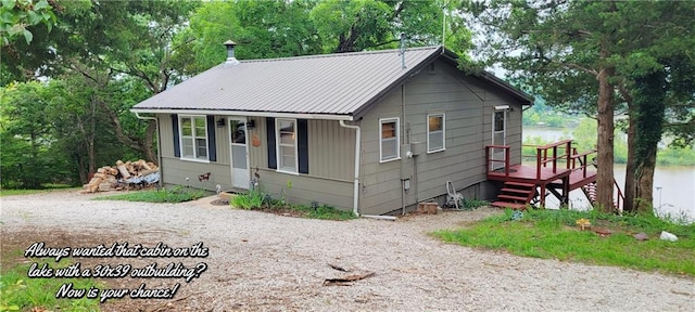28767 Parkway Dr, Warsaw, MO 65355 - bungalow-style home with a metal roof, gravel driveway, and view of wooded area
