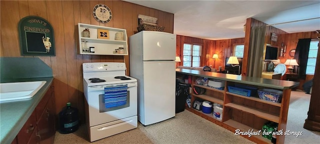 28767 Parkway Dr, Warsaw, MO 65355 - kitchen featuring white appliances, wood walls, and carpet floors