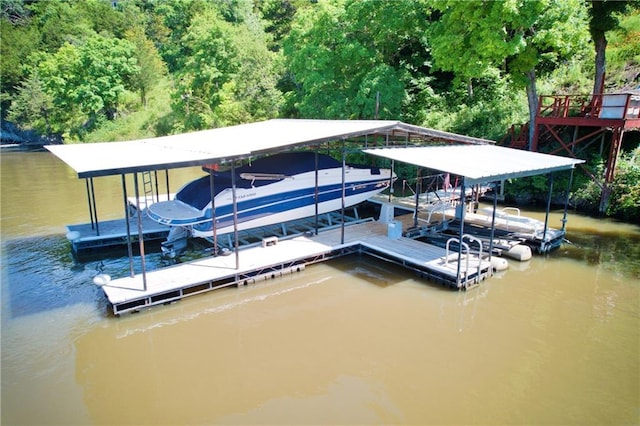 28767 Parkway Dr, Warsaw, MO 65355 - dock featuring boat lift, a water view, and a wooded view