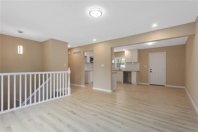 113 SW 21st St, Oak Grove, MO 64075 - unfurnished living room with light wood-style flooring and recessed lighting