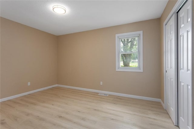 113 SW 21st St, Oak Grove, MO 64075 - unfurnished bedroom featuring light wood-type flooring and a closet