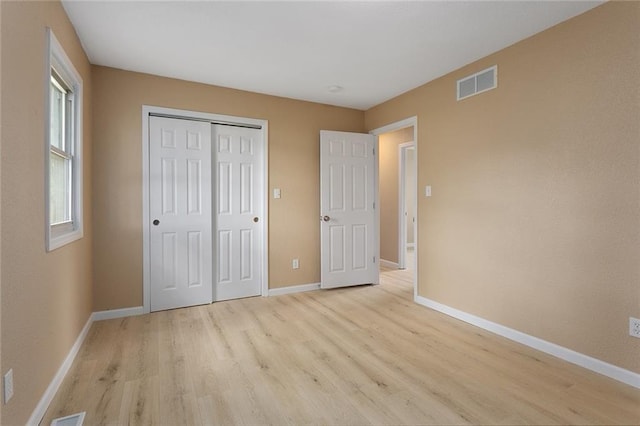 113 SW 21st St, Oak Grove, MO 64075 - unfurnished bedroom with light wood-style floors and a closet