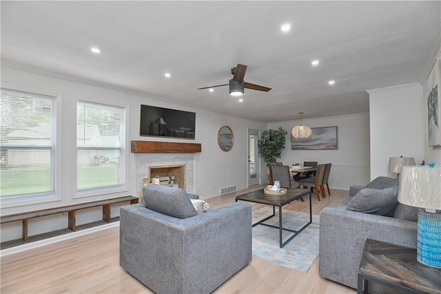 7824 Terrace St, Kansas City, MO 64114 - living area featuring crown molding, recessed lighting, a ceiling fan, a fireplace, and light wood-style flooring