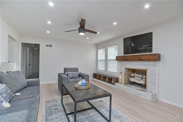 7824 Terrace St, Kansas City, MO 64114 - living area featuring ornamental molding, ceiling fan, light wood-style floors, recessed lighting, and a stone fireplace
