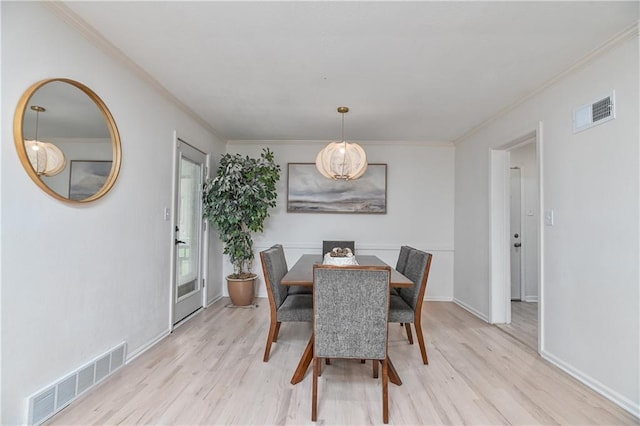 7824 Terrace St, Kansas City, MO 64114 - dining space with light wood-style flooring and ornamental molding