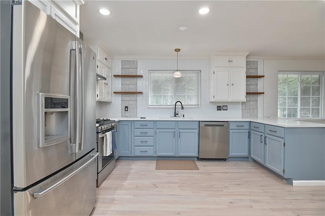7824 Terrace St, Kansas City, MO 64114 - kitchen featuring appliances with stainless steel finishes, open shelves, a peninsula, crown molding, and backsplash